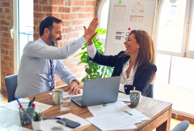 Two coworkers high-fiving